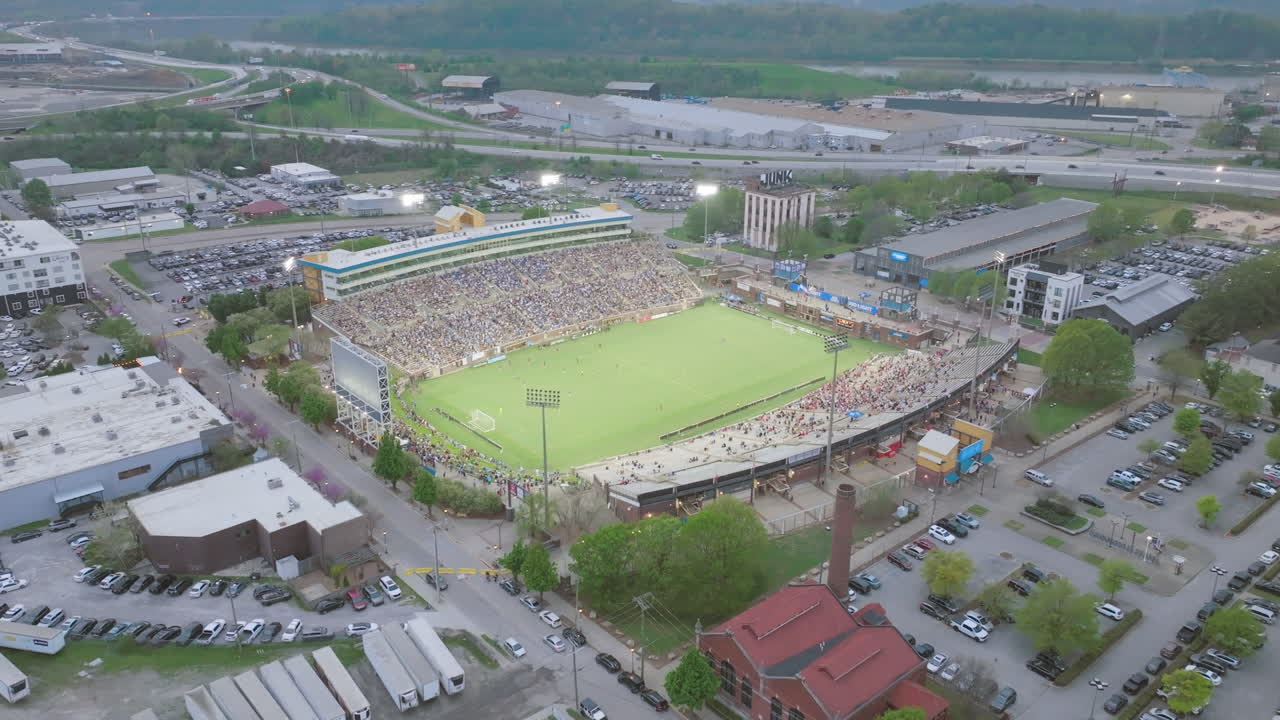 Wide aerial video rotating around Finley Stadium during a soccer game in Chattanooga, TN.