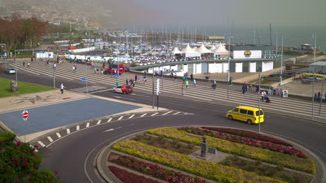 vista del paisaje urbano de un puerto deportivo y rotonda con personas