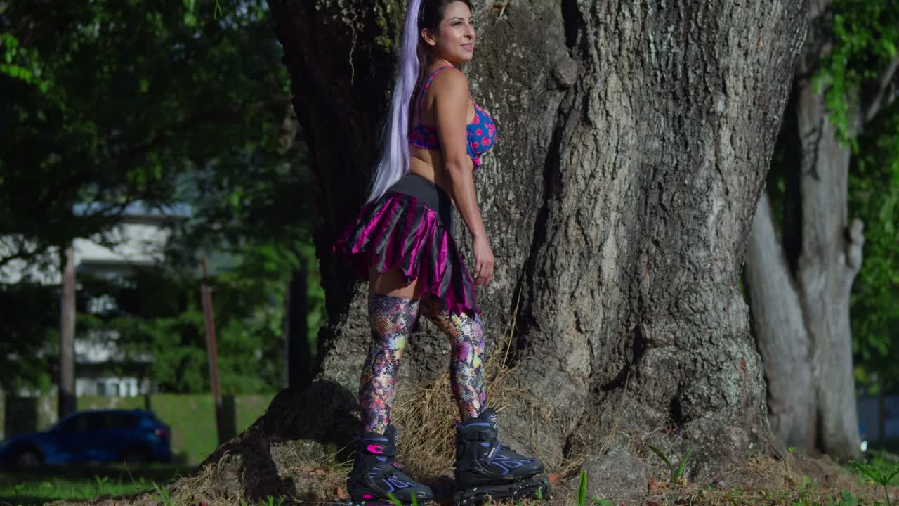 la joven usa una minifalda de patines y polainas en el parque en un día soleado
