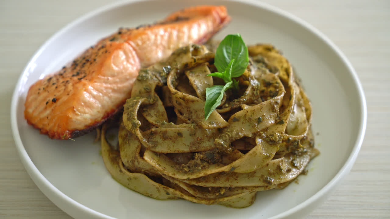 구운 연어 필레를 곁들인 홈메이드 페스토 페투치니 스파게티 파스타