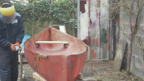 grinding off screws from a fiberglass canadian canoe