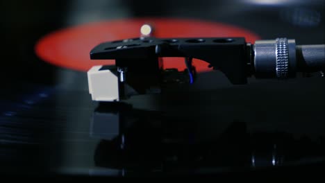 closeup needle on spinning vintage vinyl record on turntable slow motion