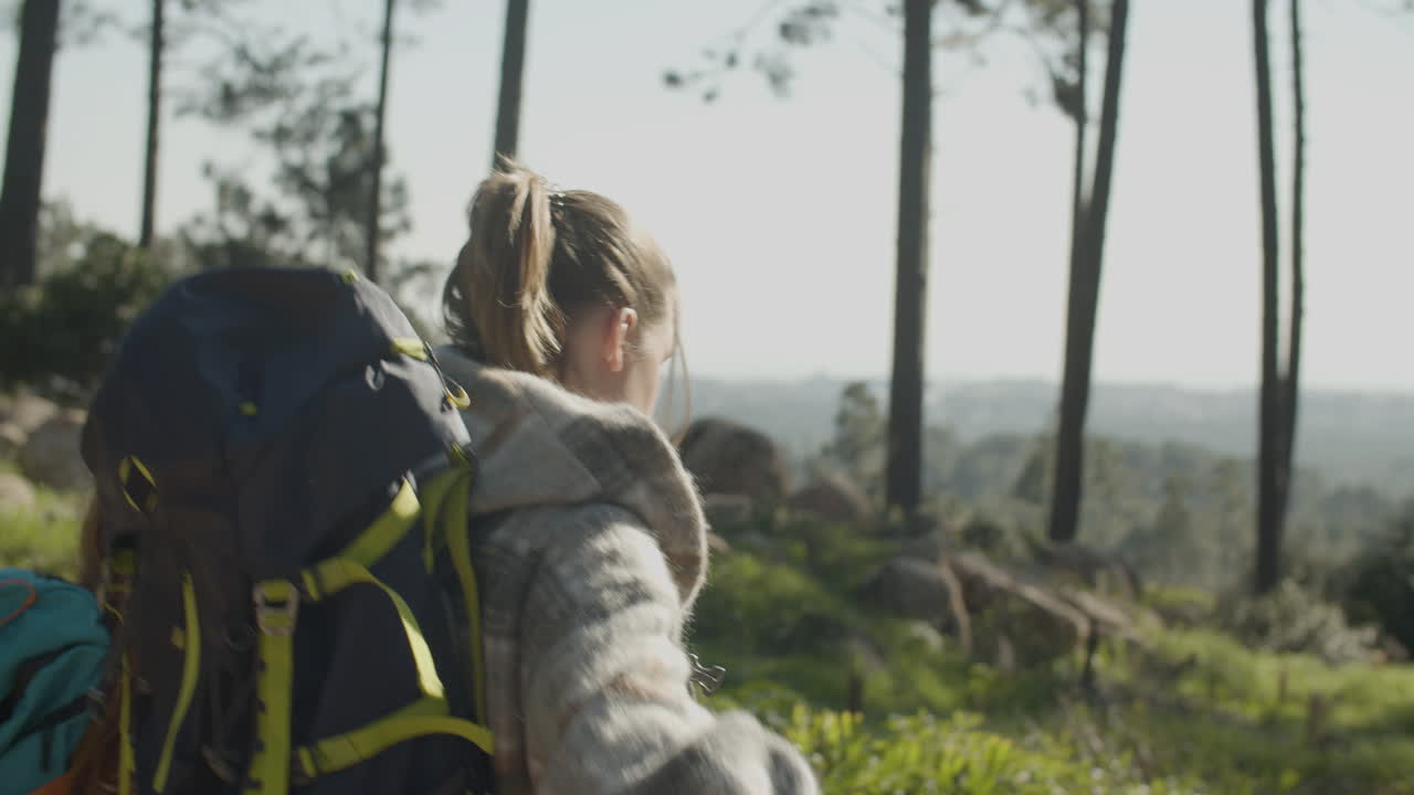 Two Female Friends With Backpacks Hiking Together In The Forest On A ...