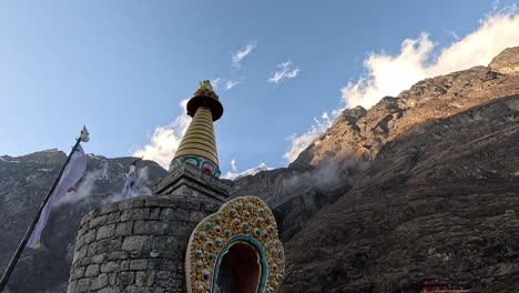 stone enlightenment stupa in front o towering himalayan mountain in evening