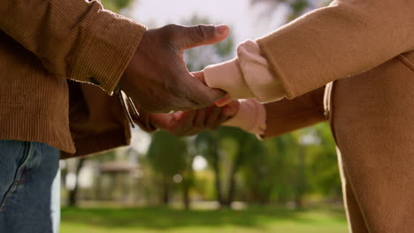 father take daughter hands in park closeup. family support emotional connection.