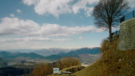 breathtaking view from the top balcony of sighignola mountain with tourists overlooking