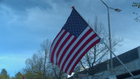 flag of usa, stars and stripes, flies diagonally in sunny spring park