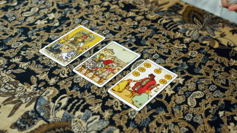 A-woman-giving-a-tarot-reading-with-chariot-the-six-of-cups-and-the-six-of-pentacles-cards