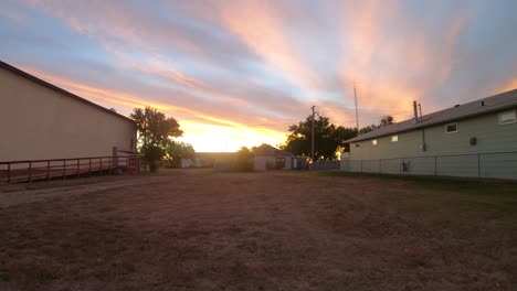 timelapse - between two buildings during dawn as the sun goes down in a small town in empress alberta canada