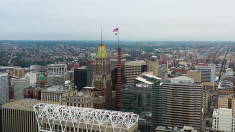 aerial view toward usa and maryland flags on top of a skyscrapers in baltimore