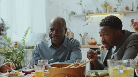 big african american family having dinner and talking at home