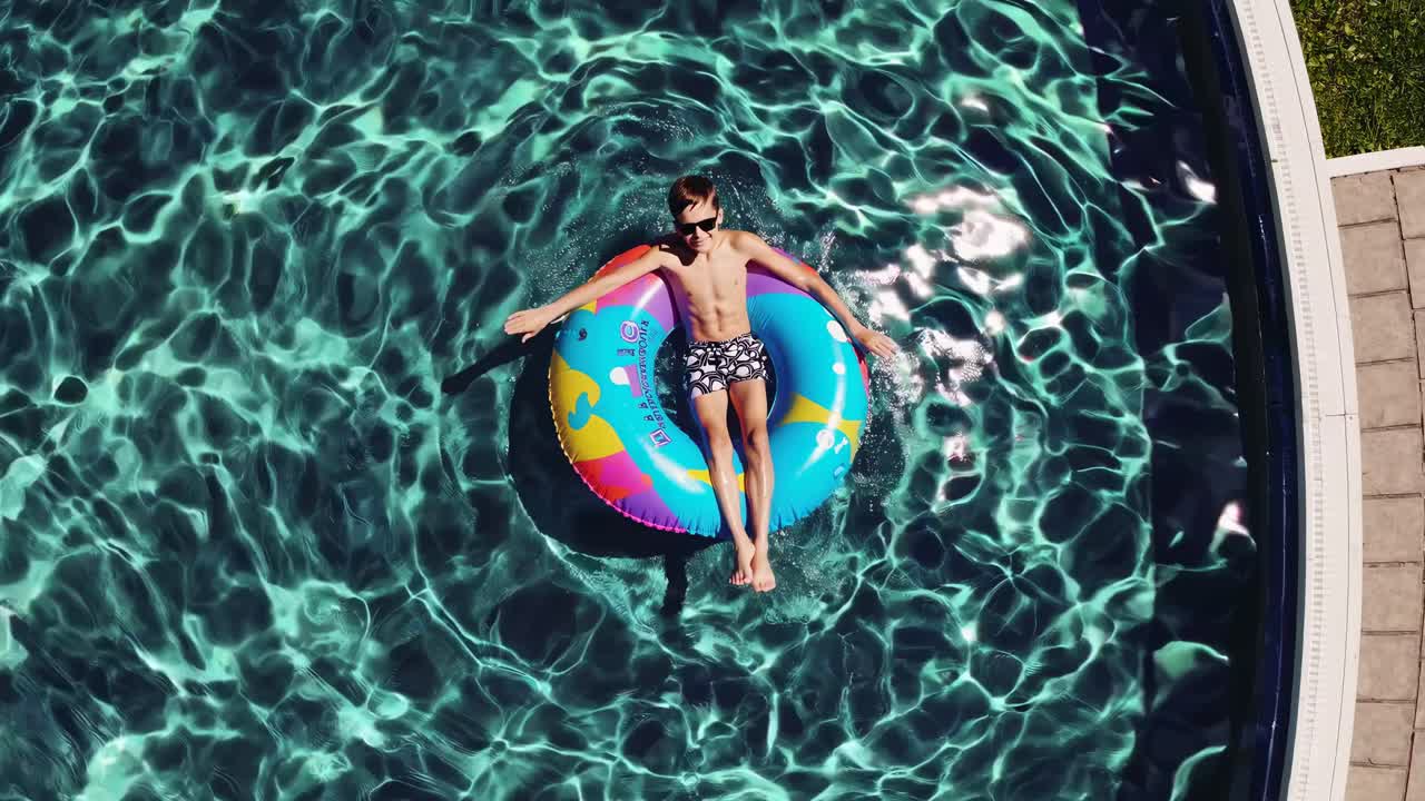 Boy floating in a pool