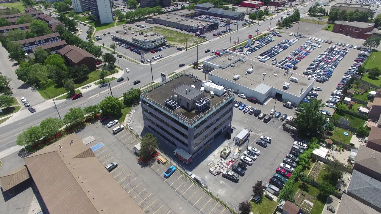 drone volando hacia un edificio industrial en una gran ciudad
