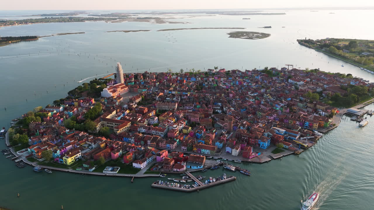 Ferry Boat Cruising In The Venetian Lagoon Near Burano Island At Sunset In Venice, Italy. - aerial shot