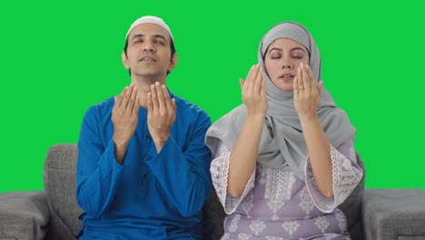 happy muslim couple reading namaz green screen