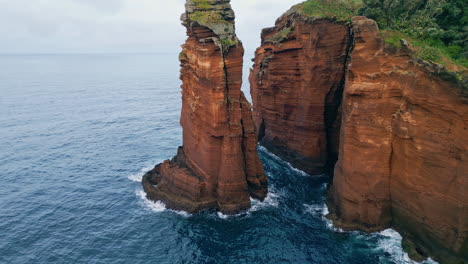 ocean cliffs formation view on cloudy day. calm water surface rippling washing