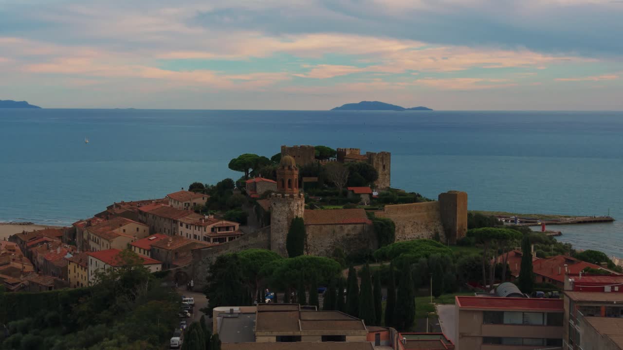Castle hilltop of Castiglione della Pescaia overlooking the sea and wide Tuscan landscapes. Aerial