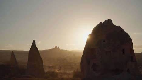 bright sunlight behind stone house in the village of goreme, cappadocia, turkey