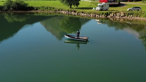 Woman-on-the-boat-catches-a-fish-on-spinning-in-Norway.