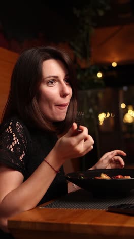 woman enjoying a seafood meal in a restaurant