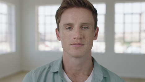 young-attractive-man-portrait-of-red-head-guy-looking-confident-pensive-at-camera-in-apartment-windows-background