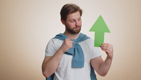 winner man holding arrow sign pointing up career growth and money exchange increase progress