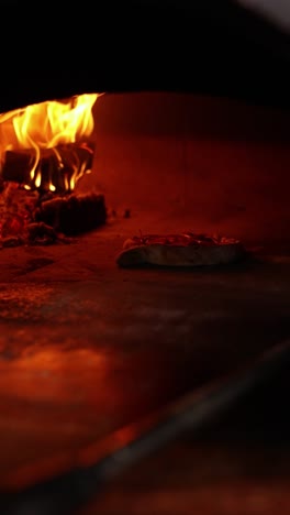 pizza baking in a wood-fired oven