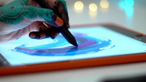 creative expression through digital art: a close-up of an artistic hand with intricate henna, skillfully drawing vibrant colors on a tablet screen