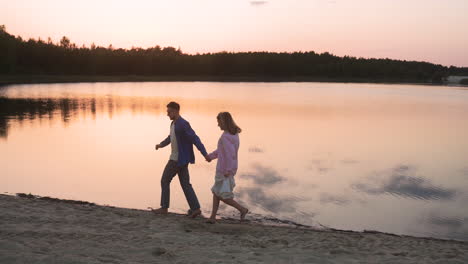 young couple kissing by the lakeshore