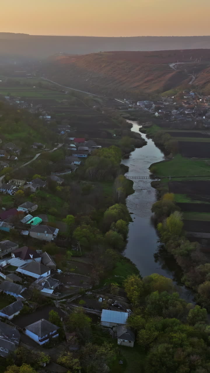 Aerial drone view of Orhei, Moldova and the Raut river at sunset. Vertical