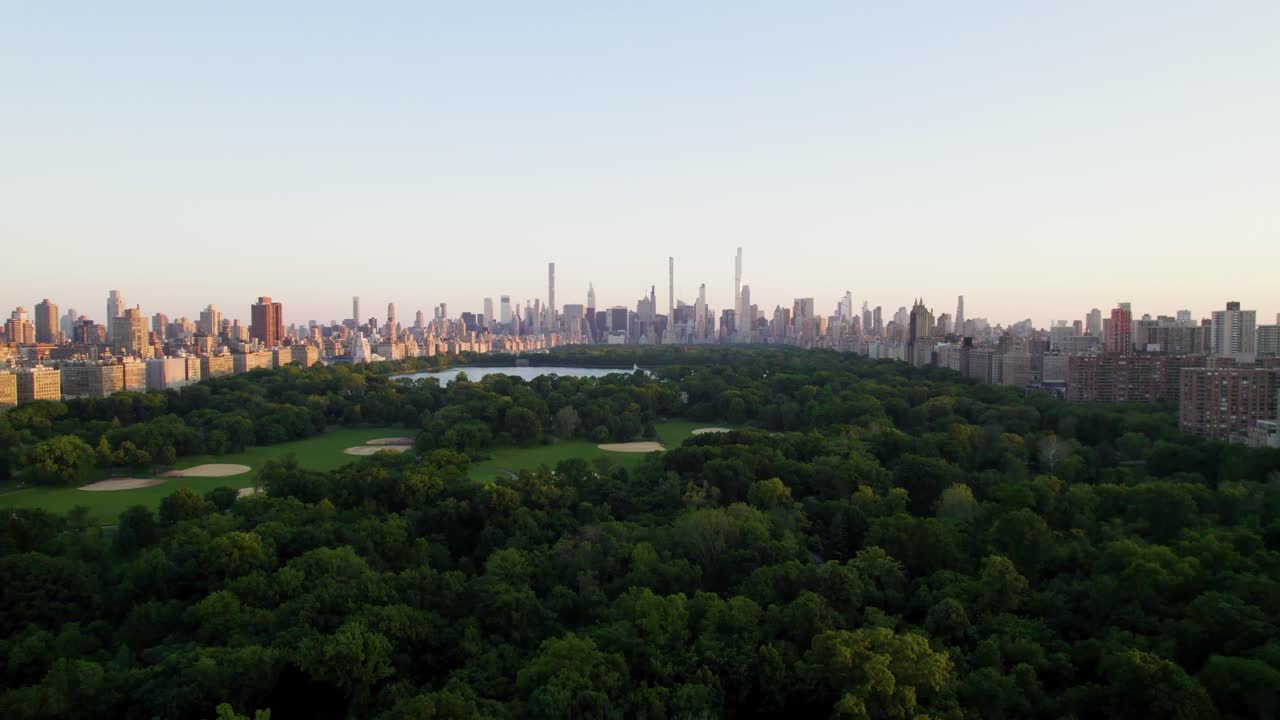 Beautiful aerial dolly shot of Central Park at sunset, NYC