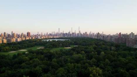 beautiful aerial dolly shot of central park at sunset, nyc