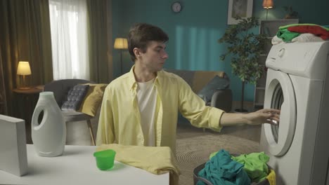 man doing laundry at home