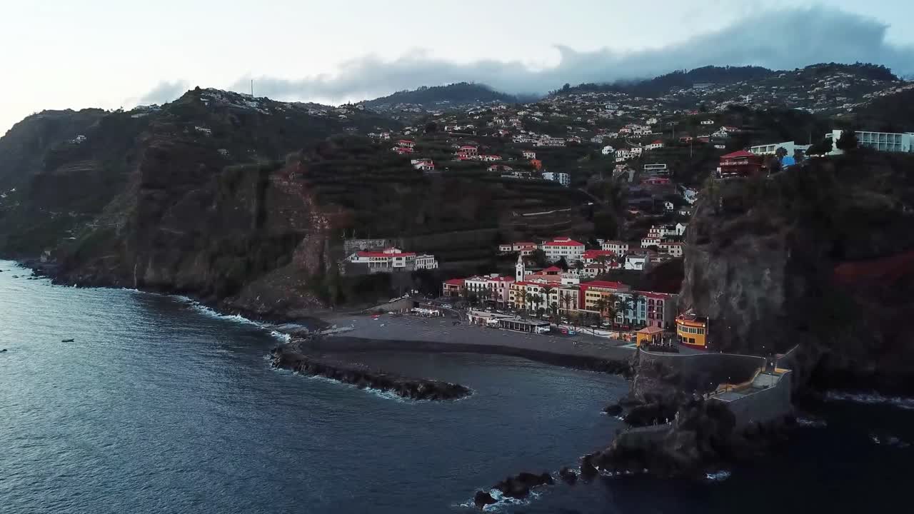 Stunning coastal scenery of Ponta do Sol, Madeira, featuring dramatic cliffs, colorful architecture, and peaceful seaside village nestled along the Atlantic Ocean with terraced hills in the background