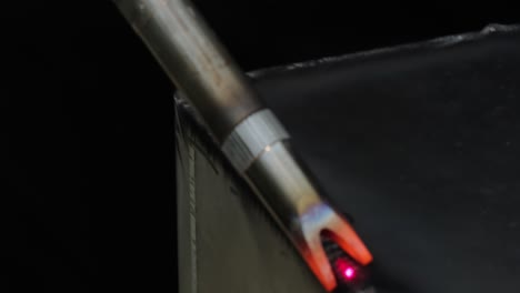 Laser-welding-machine-with-hand-hold-gun.-Laser-welding-is-shown-in-close-up.