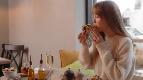 woman enjoying a pizza in a cozy cafe