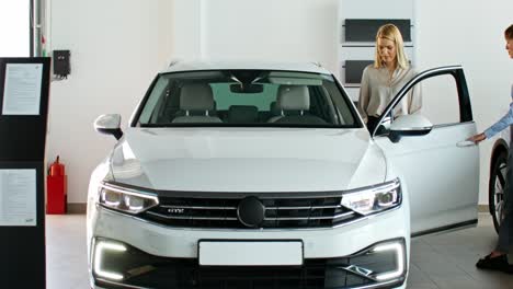 woman looking at a car in a showroom