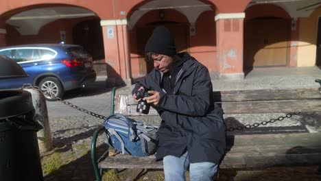 photographer taking photos on a park bench