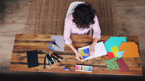 woman creating handmade cards at desk