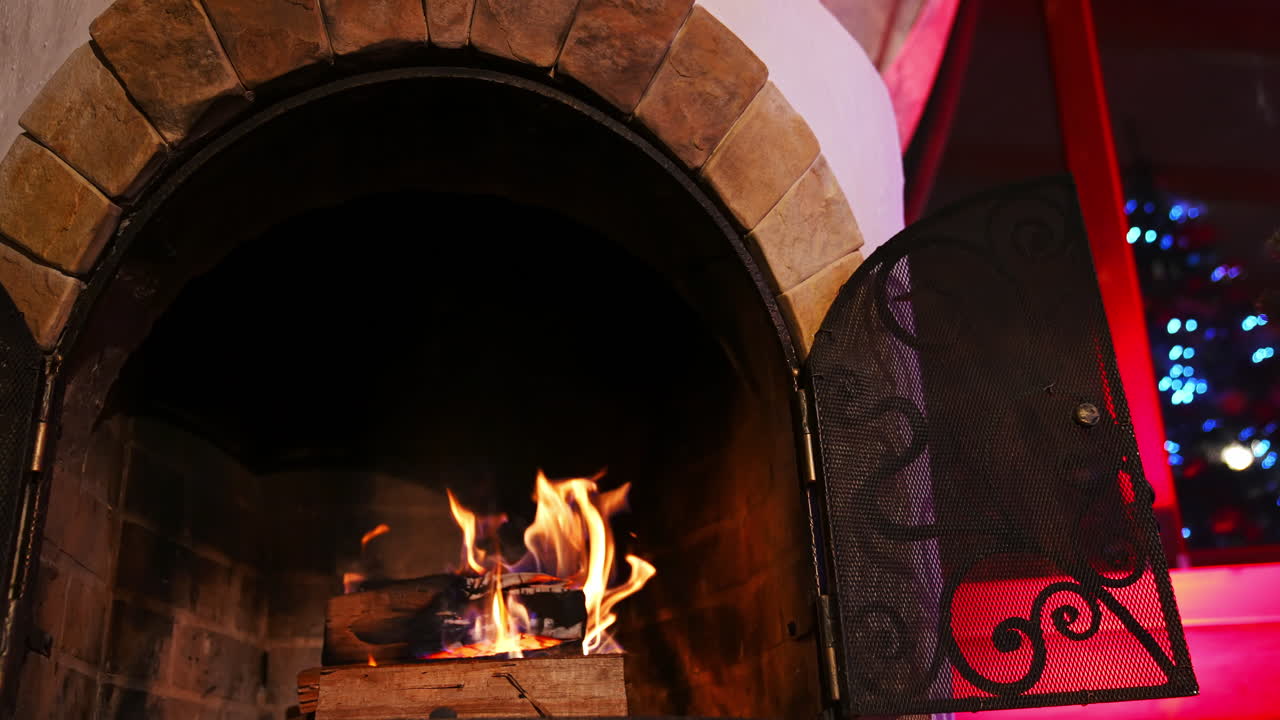 Wooden logs burning in modern fireplace. Beautiful stone fireplace at home. Romantic fireplace makes a cosy atmosphere.