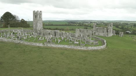 hill of slane ruins with a historic monastery and tower surrounded by lush green countryside