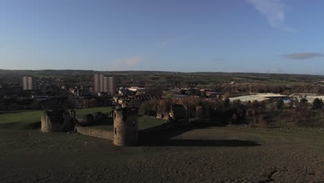 Ancient-Flint-castle-medieval-heritage-military-Welsh-ruins-aerial-view-landmark-distant-to-close-push-in