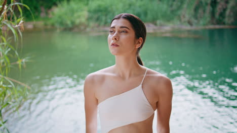 portrait tropical girl posing at lake nature. feminine woman in wild jungles