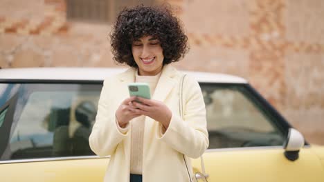 young woman smiling confident using smartphone at street