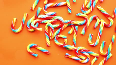 Mini-cherry-candy-canes-on-orange-background-,