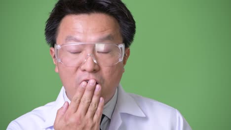 mature japanese man doctor wearing protective glasses