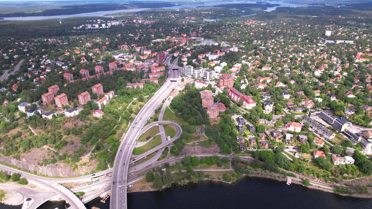 Aerial View of a Cityscape with Highways and Green Areas by a Lake