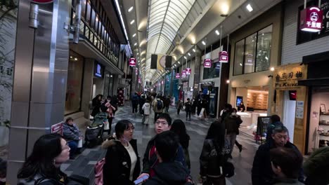 people walking through a bustling shopping street