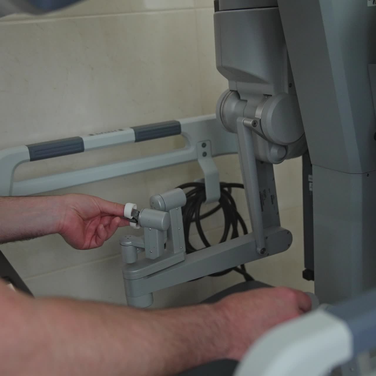 Innovative advanced equipment at modern hospital. Male hands rule the futuristic machine moving slowly. Close up