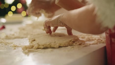 handheld view of child rolling the dough